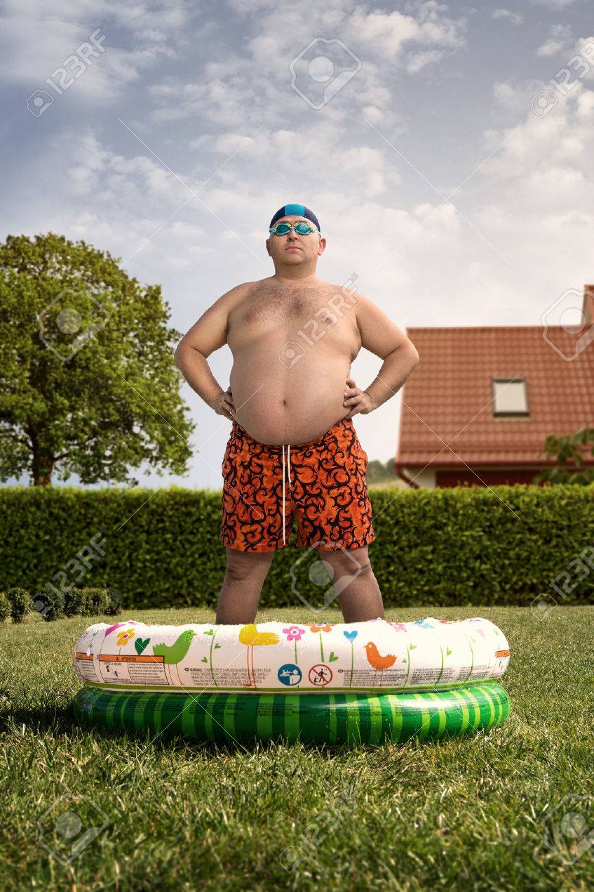 Cheap holidays at home, funny overweight man about to swim in the back yard pool - 31475653 Cheap holidays at home, funny overweight man about to swim in the back yard pool - 31475653