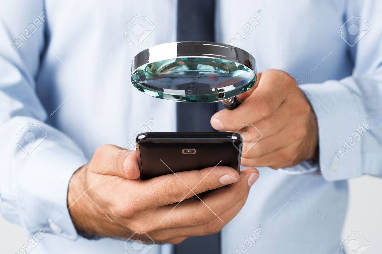 Close up of young businessman searching the mobile phone - 45327544 Close up of young businessman searching the mobile phone - 45327544