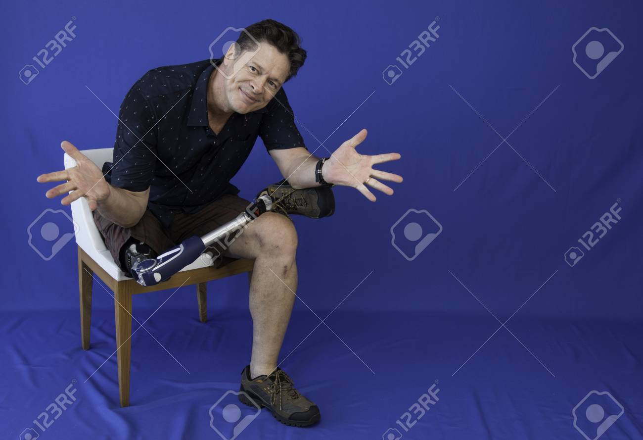 Middle-aged man with physical disability, happy with life sitting on the chair - 95723893 Middle-aged man with physical disability, happy with life sitting on the chair - 95723893