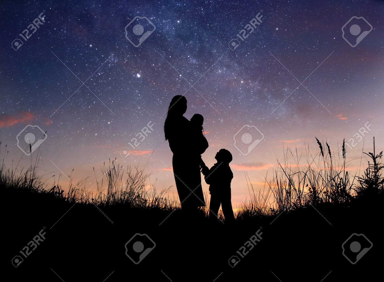 Silhouette of mother and her two little children against starry night sky - 66479359 Silhouette of mother and her two little children against starry night sky - 66479359