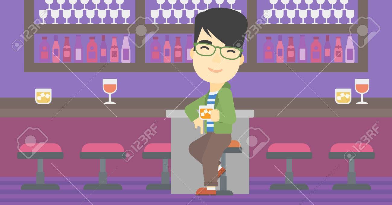 an asian man sitting at the bar counter man sitting with glass counterman
