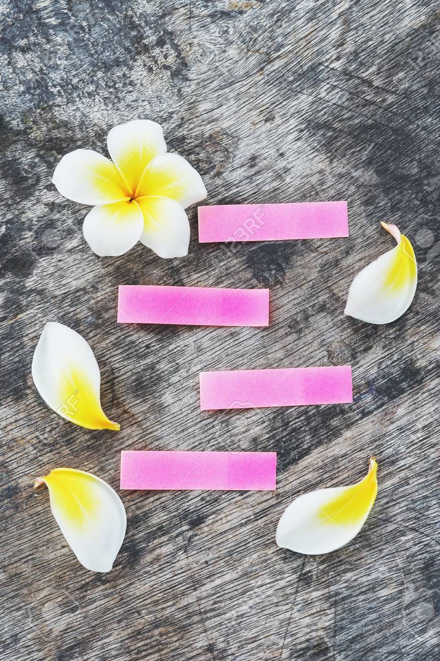 blank old pink paper on grunge wood with plumeria flower plumeria paper flower