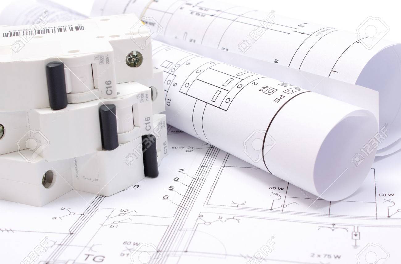 rolled electrical diagrams and electric fuse lying on construction drawing of house drawings for the rolled electrical diagrams and electric fuse lying on construction drawing of house drawings for the