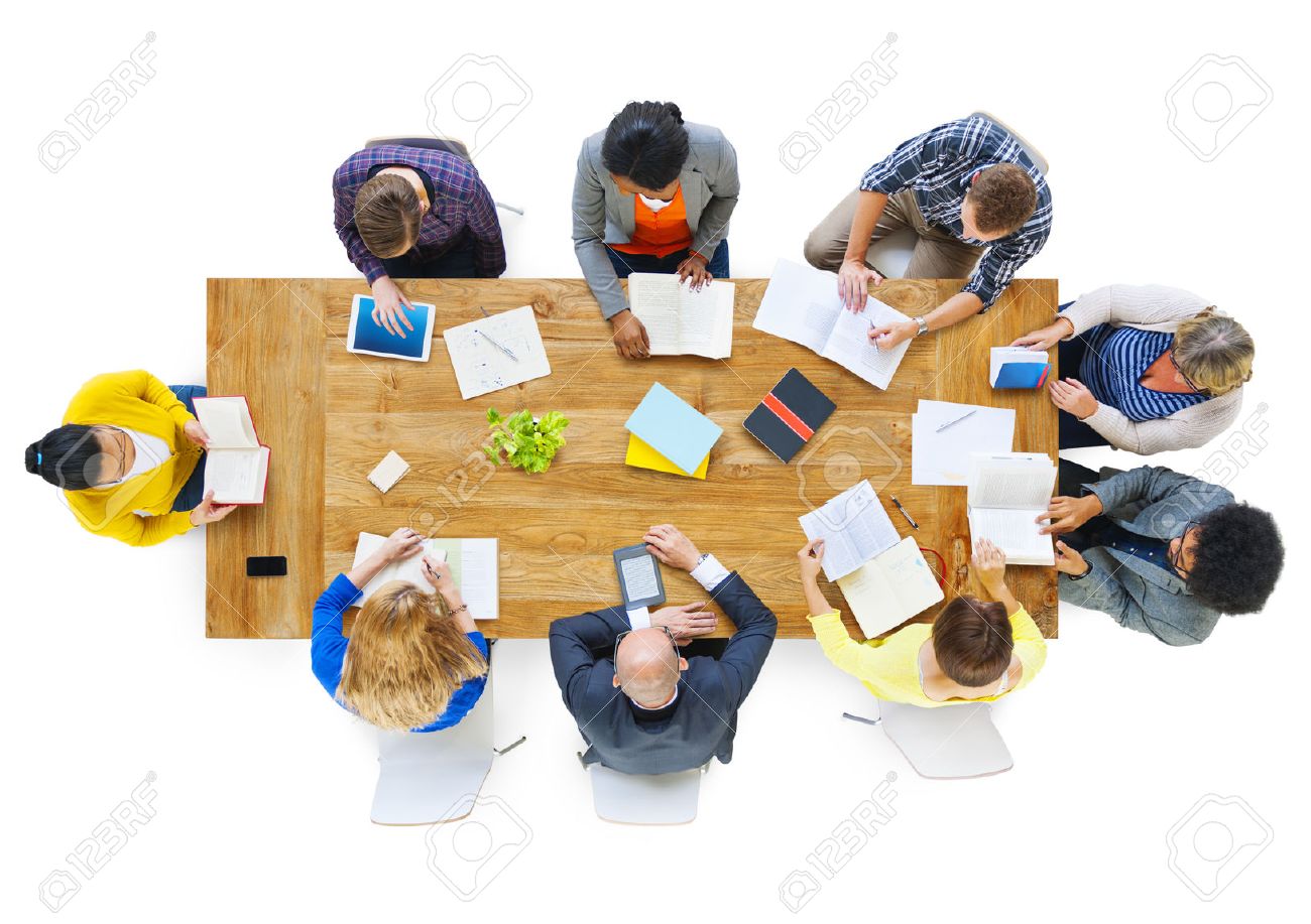 Group of Busienss People Reading Notes on a Meeting Table - 28864055 Group of Busienss People Reading Notes on a Meeting Table - 28864055