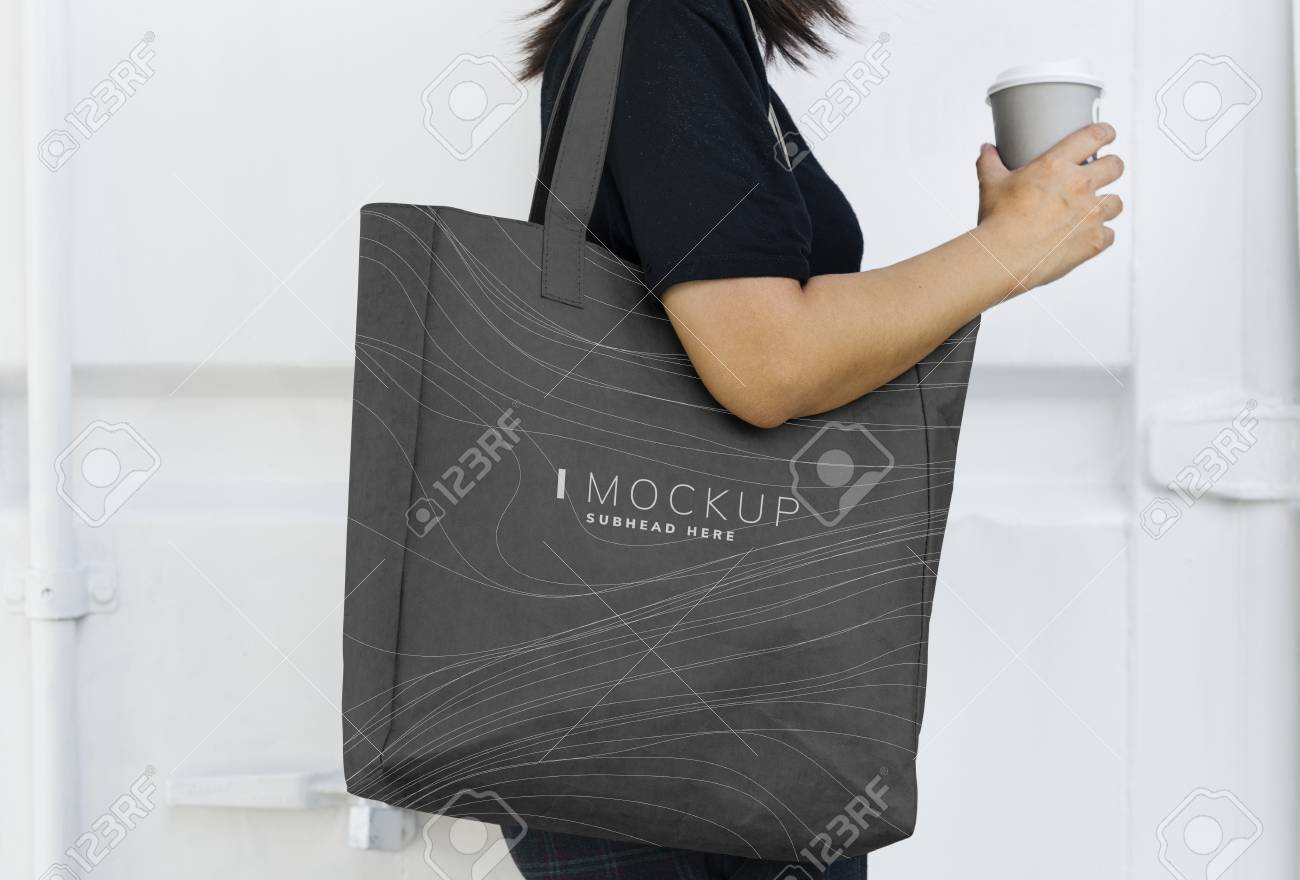 Woman carrying a black shopping bag mockup - 111300278 Woman carrying a black shopping bag mockup - 111300278