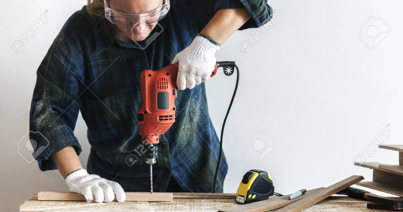 Handyman Using A Hand Drilling Machine 
