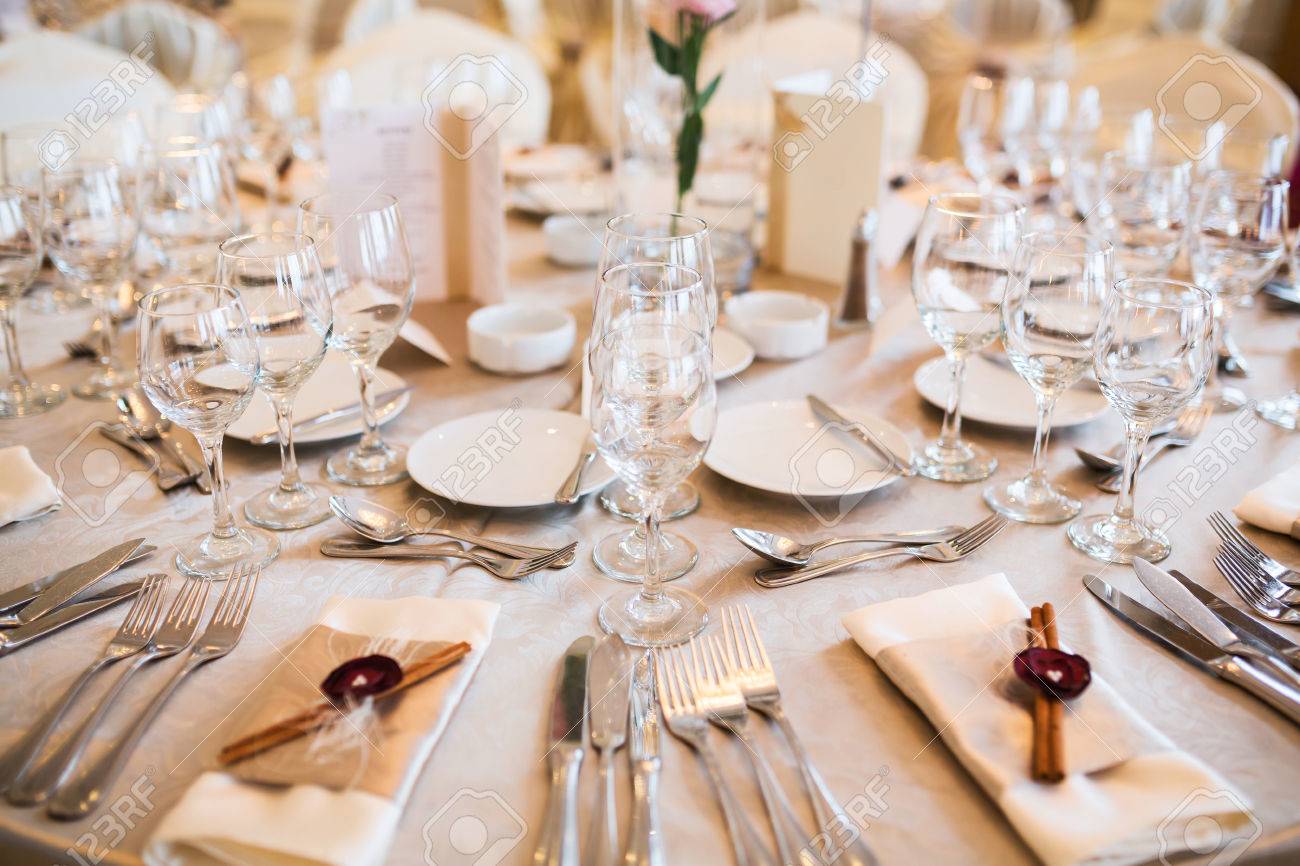 romantic wedding table arrangement with beige tablecloth and stock