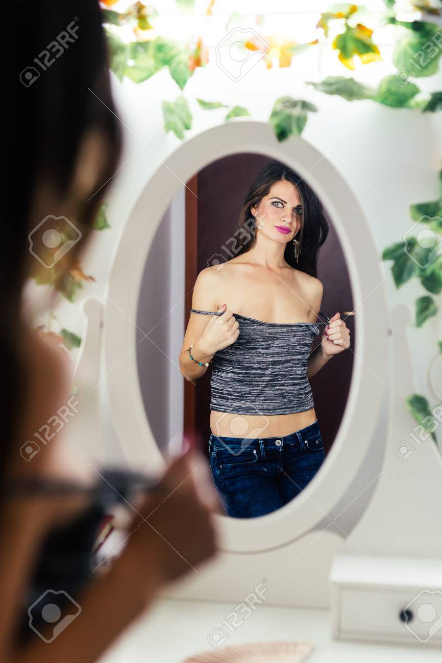 Cute Woman Undressing In Front Of The picture