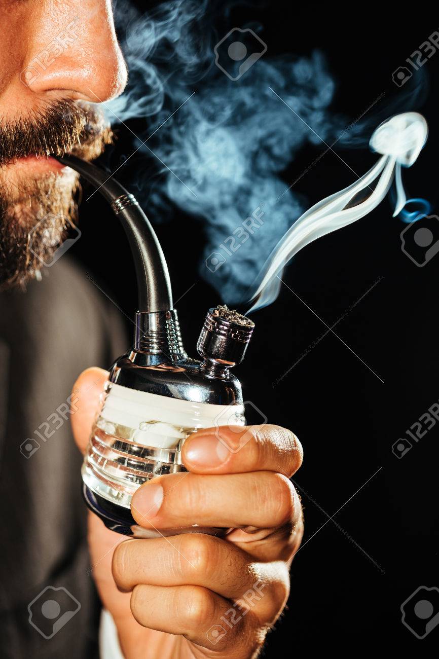 smoking weed out of a tobacco pipe Man Smoking Marijuana Using A Pipe Stock Photo, Picture and Royalty Free  Image. Image 64518636