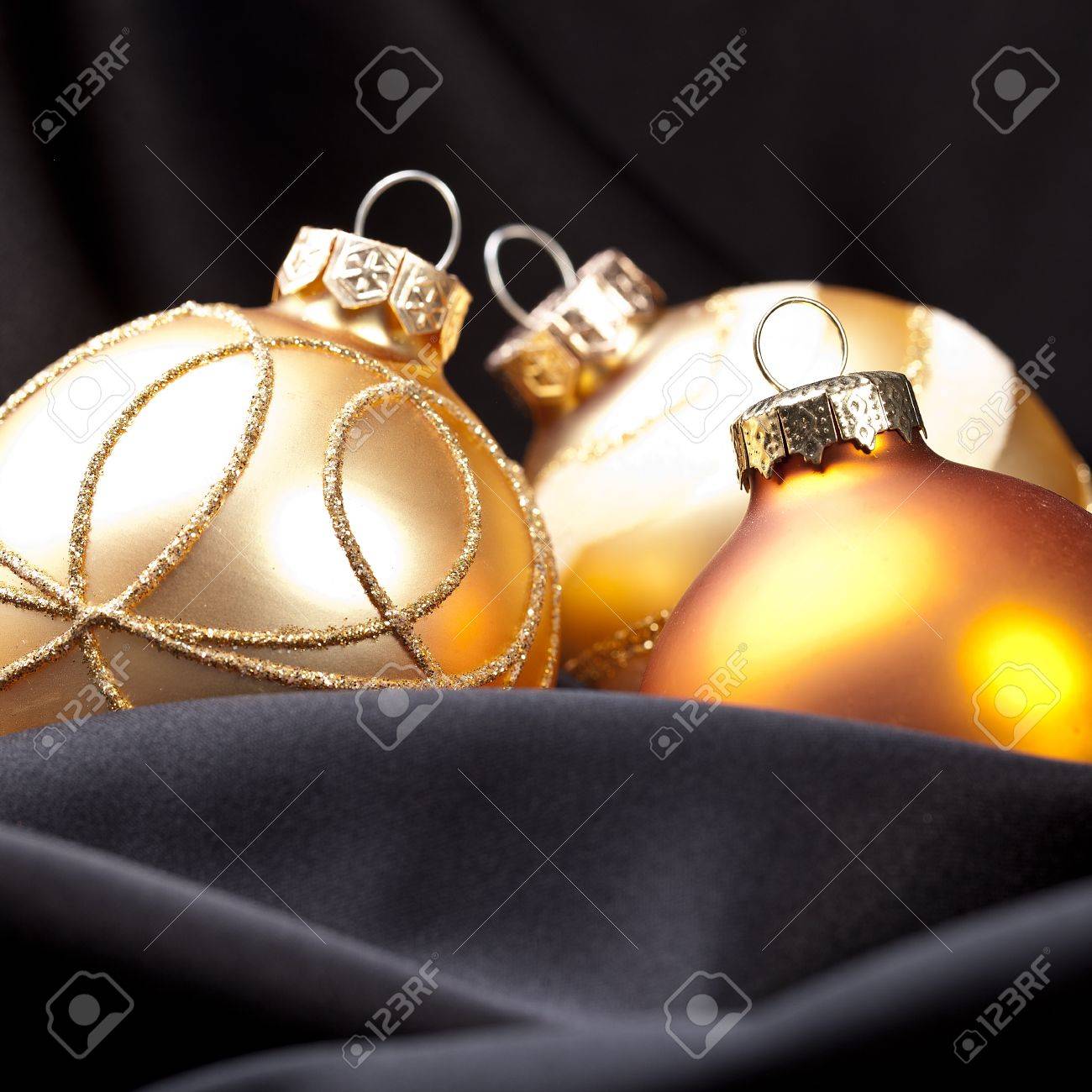 three golden christmas balls on silk stock photo picture and silk christmas balls