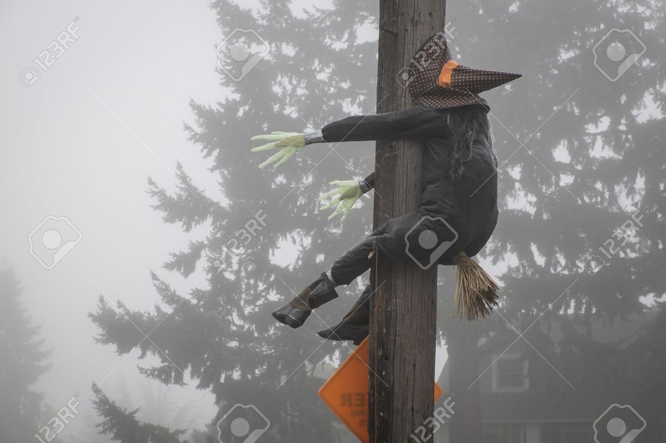 Stuffed Halloween witch crashing into a telephone pole - 22941672 Stuffed Halloween witch crashing into a telephone pole - 22941672