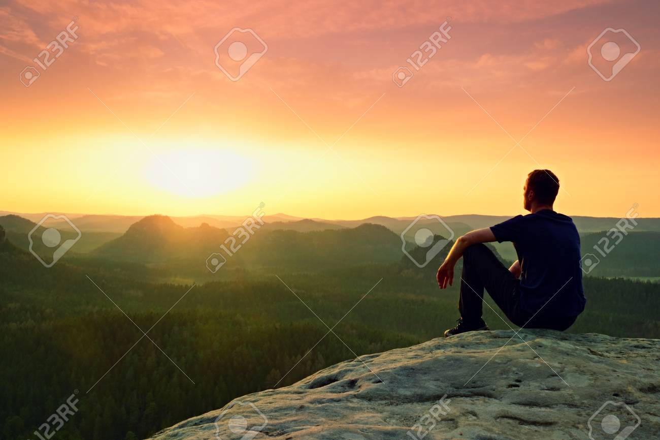 Moment Of Loneliness Man Sit On The Peak Of Rock And Watching Stock Photo Picture And Royalty Free Image Image Moment Of Loneliness Man Sit On The Peak Of Rock And Watching Stock Photo Picture And Royalty Free Image Image
