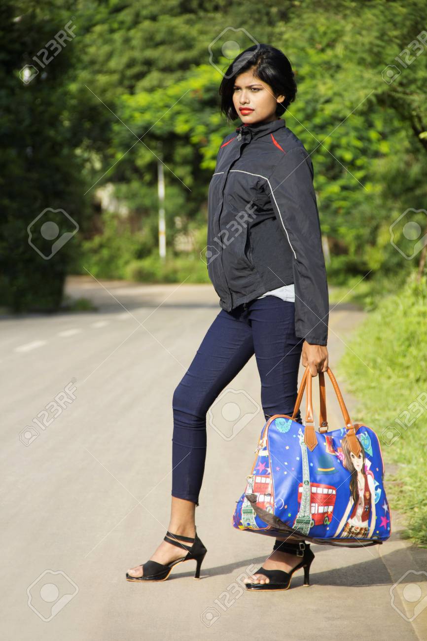 Beautiful Young Indian Girl With Short Hairs Holding Luggage