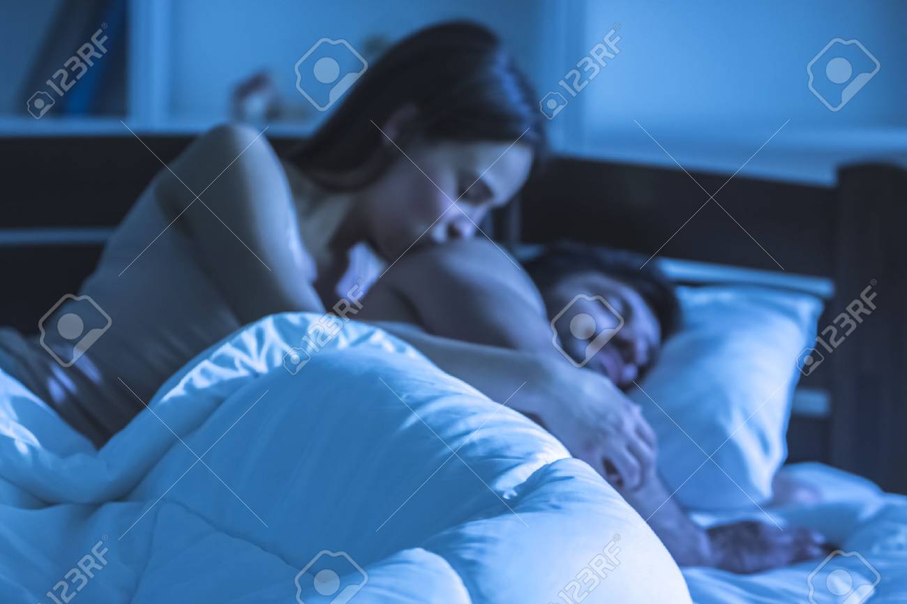 The Woman Kissing A Sleeping Man In The Bed Night Time Stock
