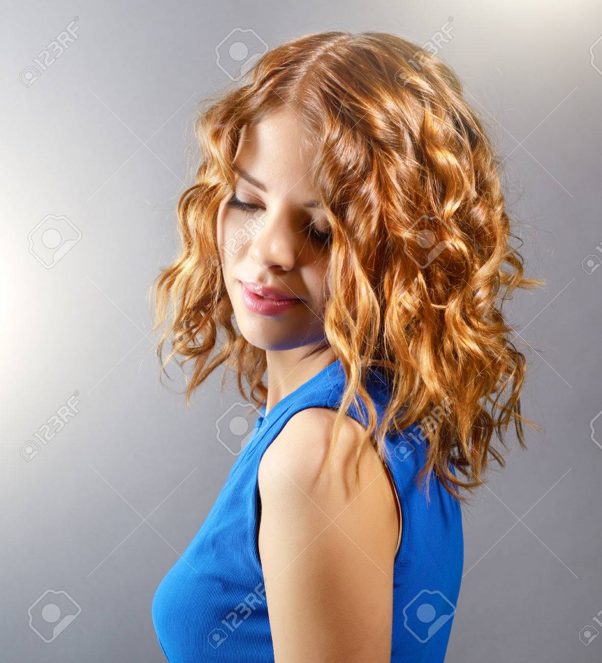 Pretty Girl With Short Curly Hair On Light Background