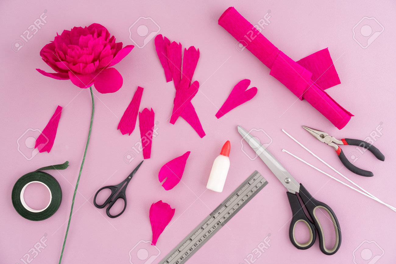 utensils and tools for making crepe paper flowers on pink wooden paper flower making tools