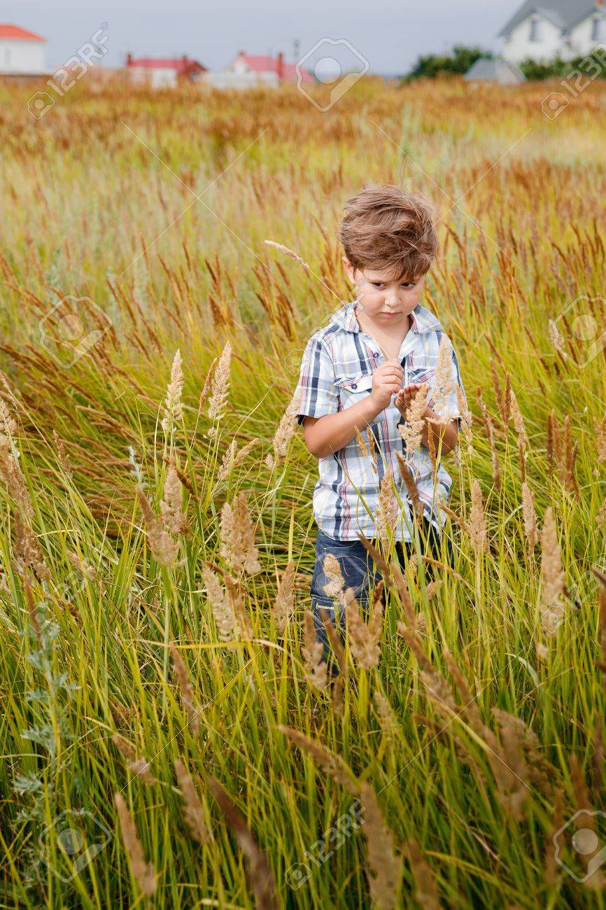 Joyful Little Boy Running Around In A Field Stock Photo, Picture and  Royalty Free Image. Image 15796313.