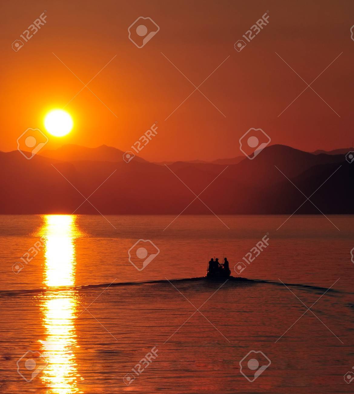 fishermen boat leaving harbour at sunset - 32754211 fishermen boat leaving harbour at sunset - 32754211