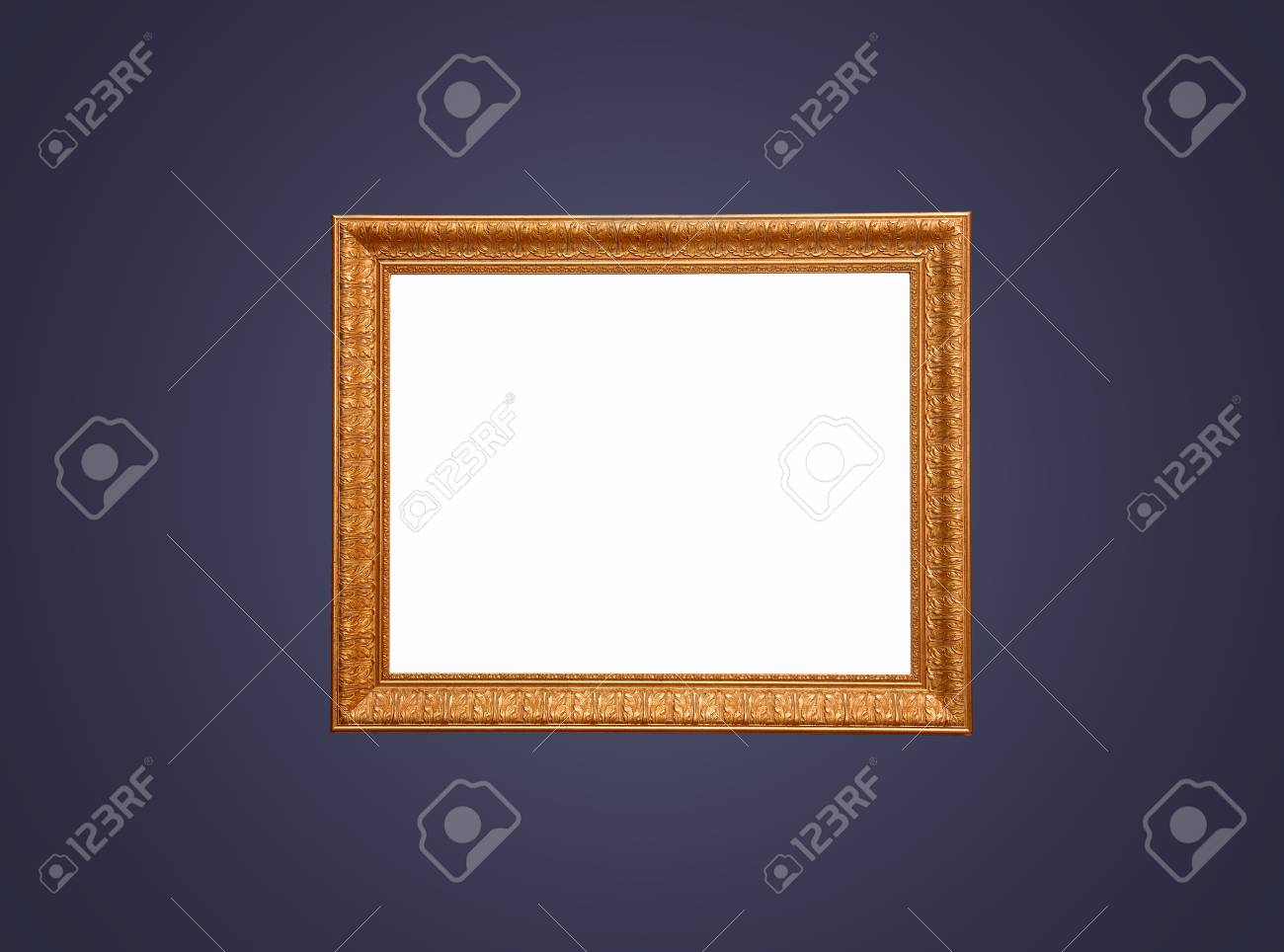 An wood and gold leaf empty frame for painting on a dark blue background. - 43271240 An wood and gold leaf empty frame for painting on a dark blue background. - 43271240