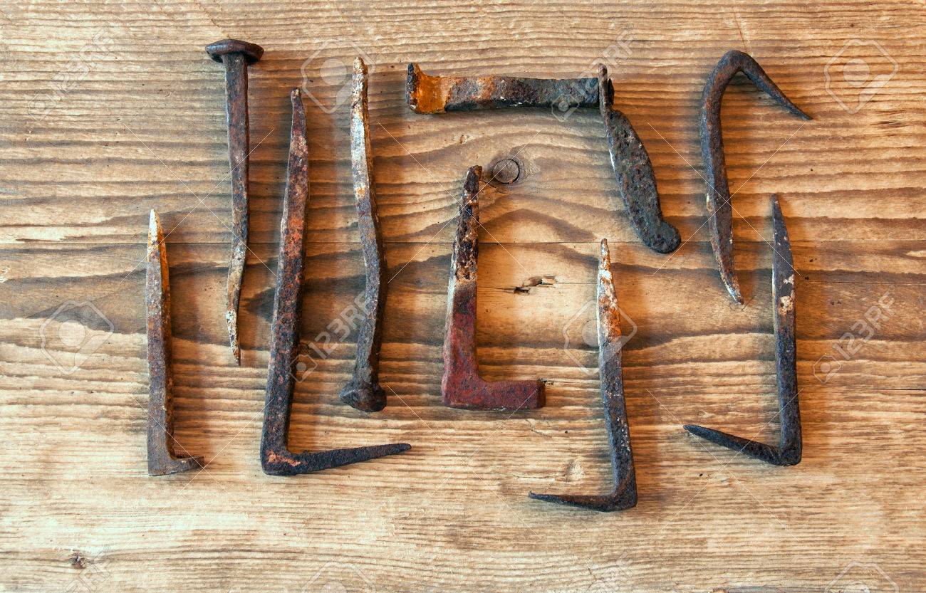 Set of rusty old big nails on a wooden background - 43271250 Set of rusty old big nails on a wooden background - 43271250