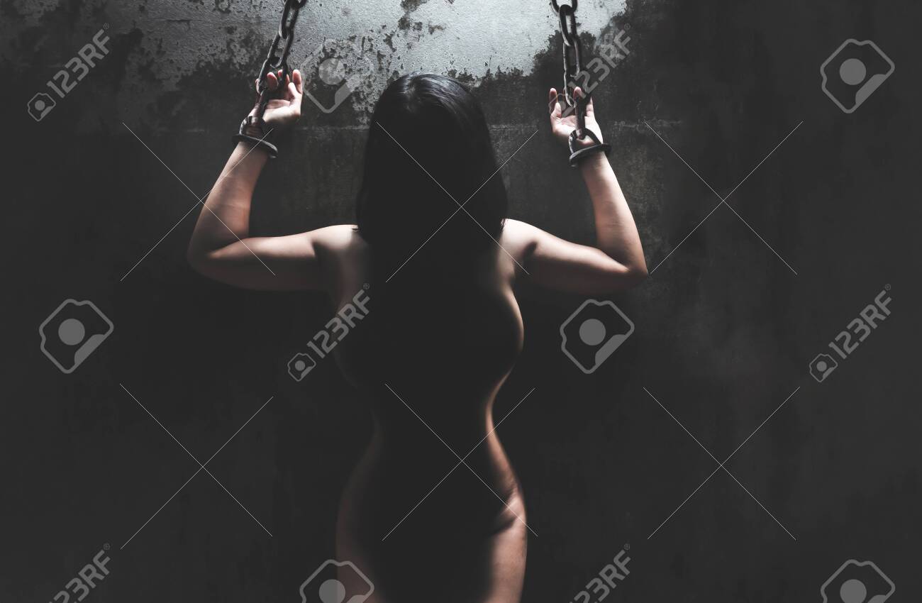 Woman Bare Body Hands Bondage With Old Rusty Metal Chain In The Dark Room,  Conceptual Image Sex Abuse Rape Фотография, картинки, изображения и  сток-фотография без роялти. Image 157854055