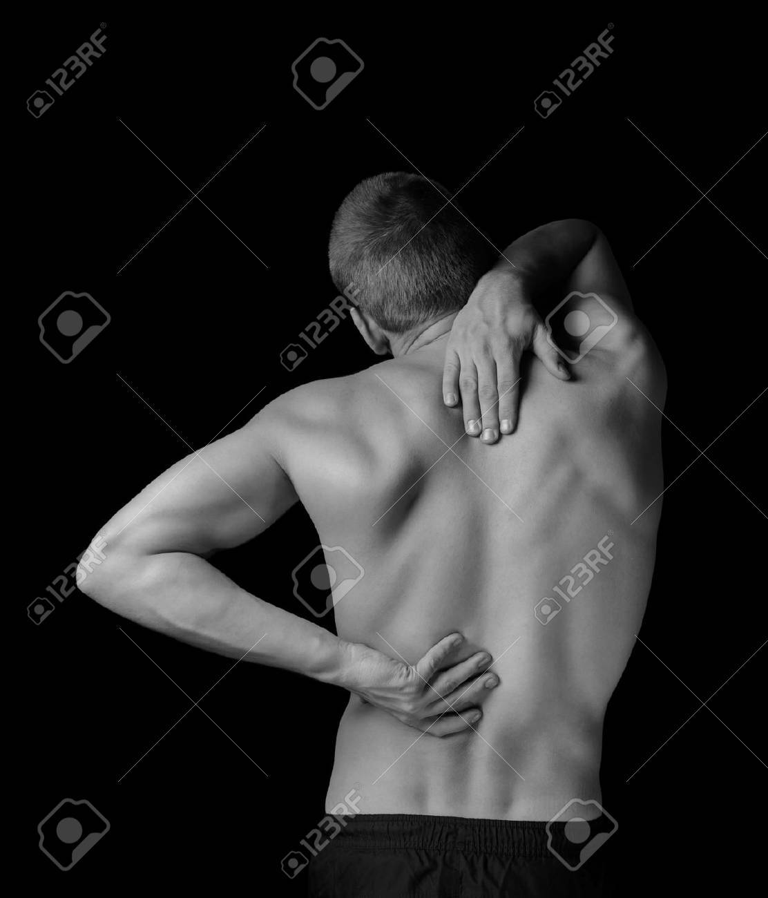 Man is touching the back, concept of pain in the spine, monochrome image - 37763058 Man is touching the back, concept of pain in the spine, monochrome image - 37763058
