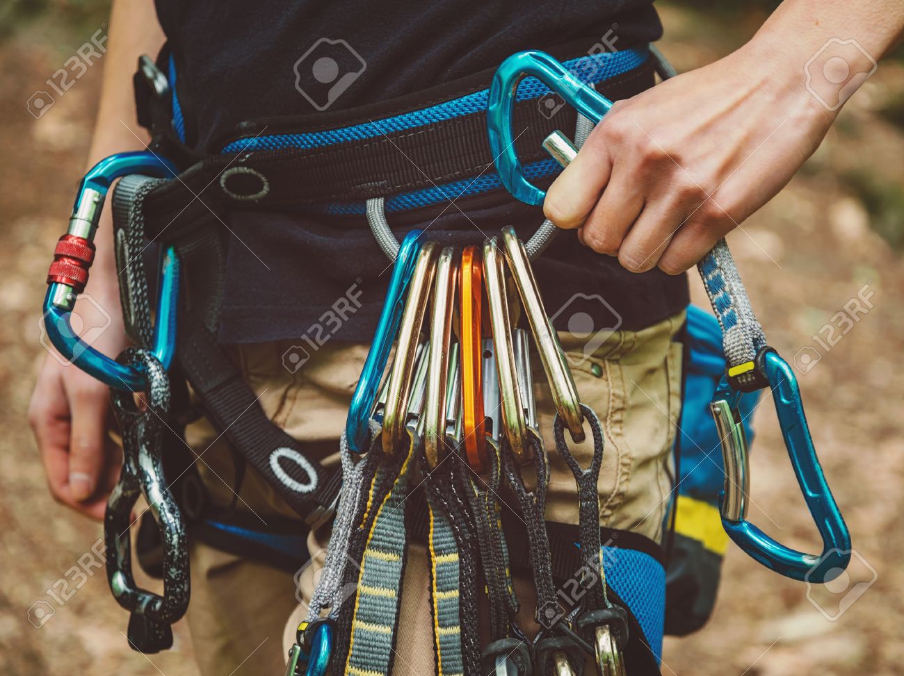 Close-up of female rock climber wearing safety harness with quickdraws and climbing equipment outdoor - 40985720 Close-up of female rock climber wearing safety harness with quickdraws and climbing equipment outdoor - 40985720