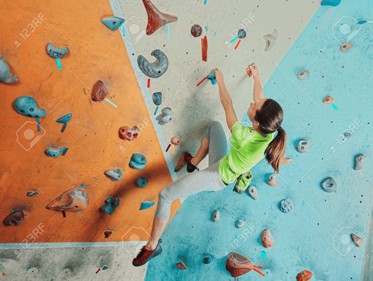 Beautiful sporty young woman climbing on practical wall in gym, bouldering - 41544008 Beautiful sporty young woman climbing on practical wall in gym, bouldering - 41544008