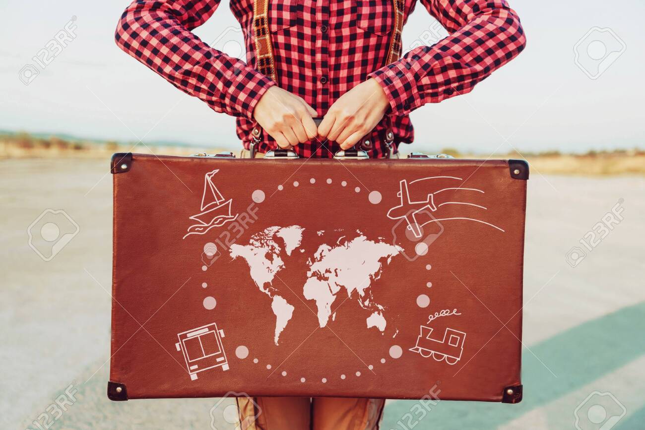 Traveler woman standing with a suitcase. Map of the world and types of transport are painted on suitcase. Concept of travel - 128514119 Traveler woman standing with a suitcase. Map of the world and types of transport are painted on suitcase. Concept of travel - 128514119