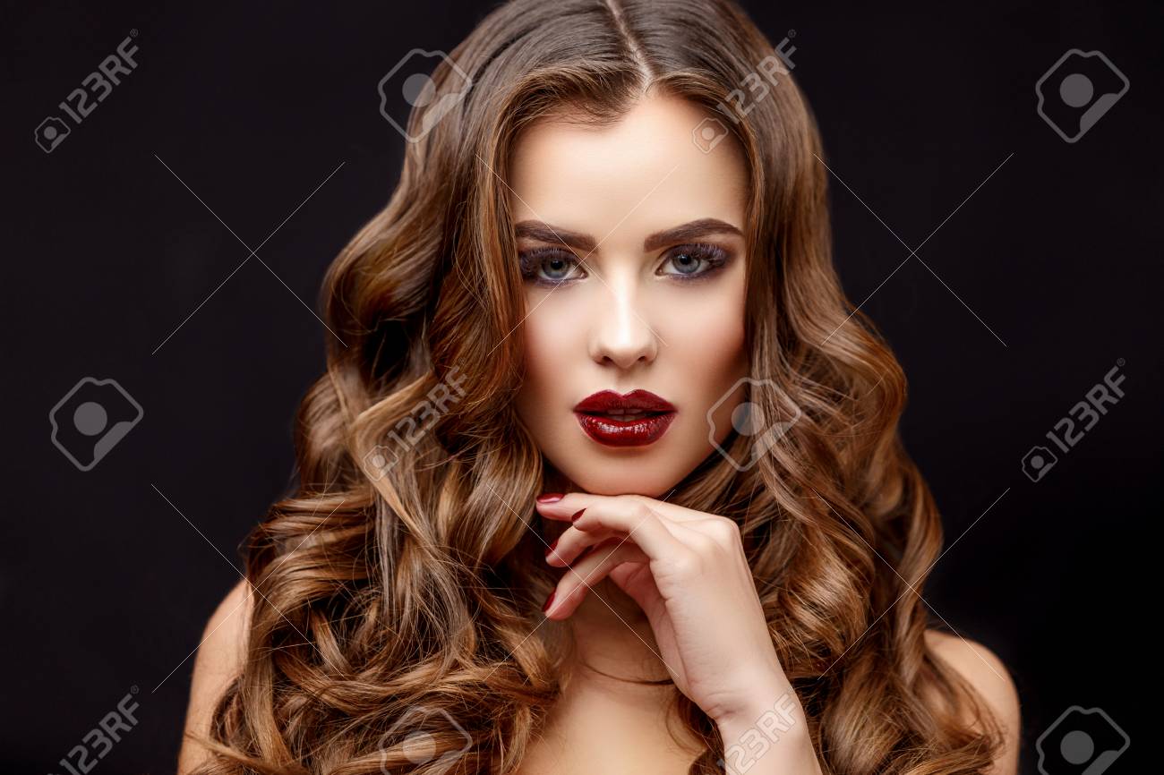 Beautiful Face of Young Woman with Clean Fresh Skin and healthy curly hair close up on black background - 61600292 Beautiful Face of Young Woman with Clean Fresh Skin and healthy curly hair close up on black background - 61600292