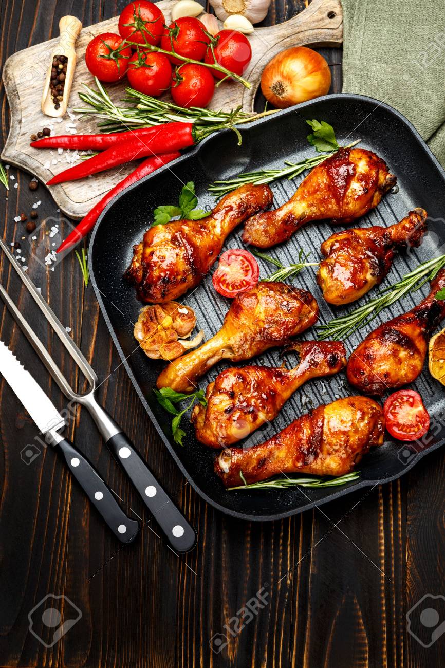 roasted chicken legs with herbs on wooden table - 62136139 roasted chicken legs with herbs on wooden table - 62136139