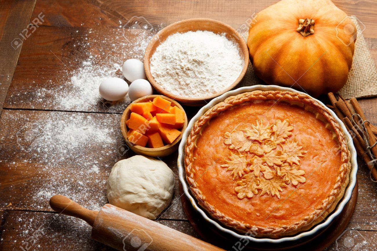Traditional american fresh round bright orange homemade pumpkin pie in baking dish on wooden table - 65315771 Traditional american fresh round bright orange homemade pumpkin pie in baking dish on wooden table - 65315771