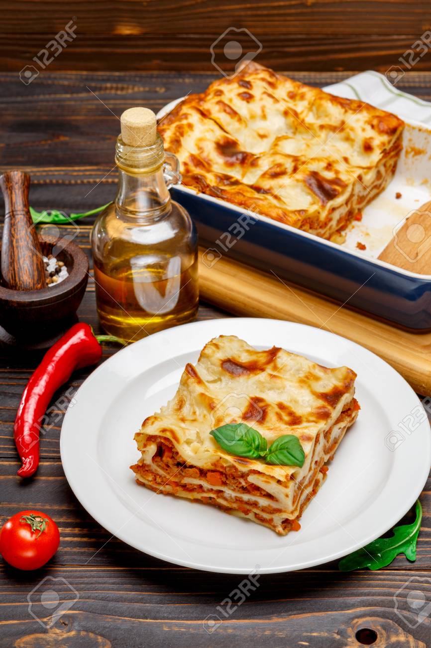 Portion of tasty lasagna on wooden backgound - 78054814 Portion of tasty lasagna on wooden backgound - 78054814