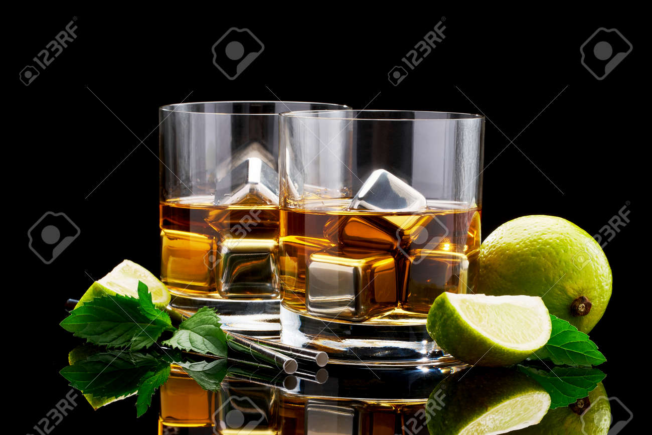 Whiskey with steel cooling cubes on dark glass background - 169835469 Whiskey with steel cooling cubes on dark glass background - 169835469