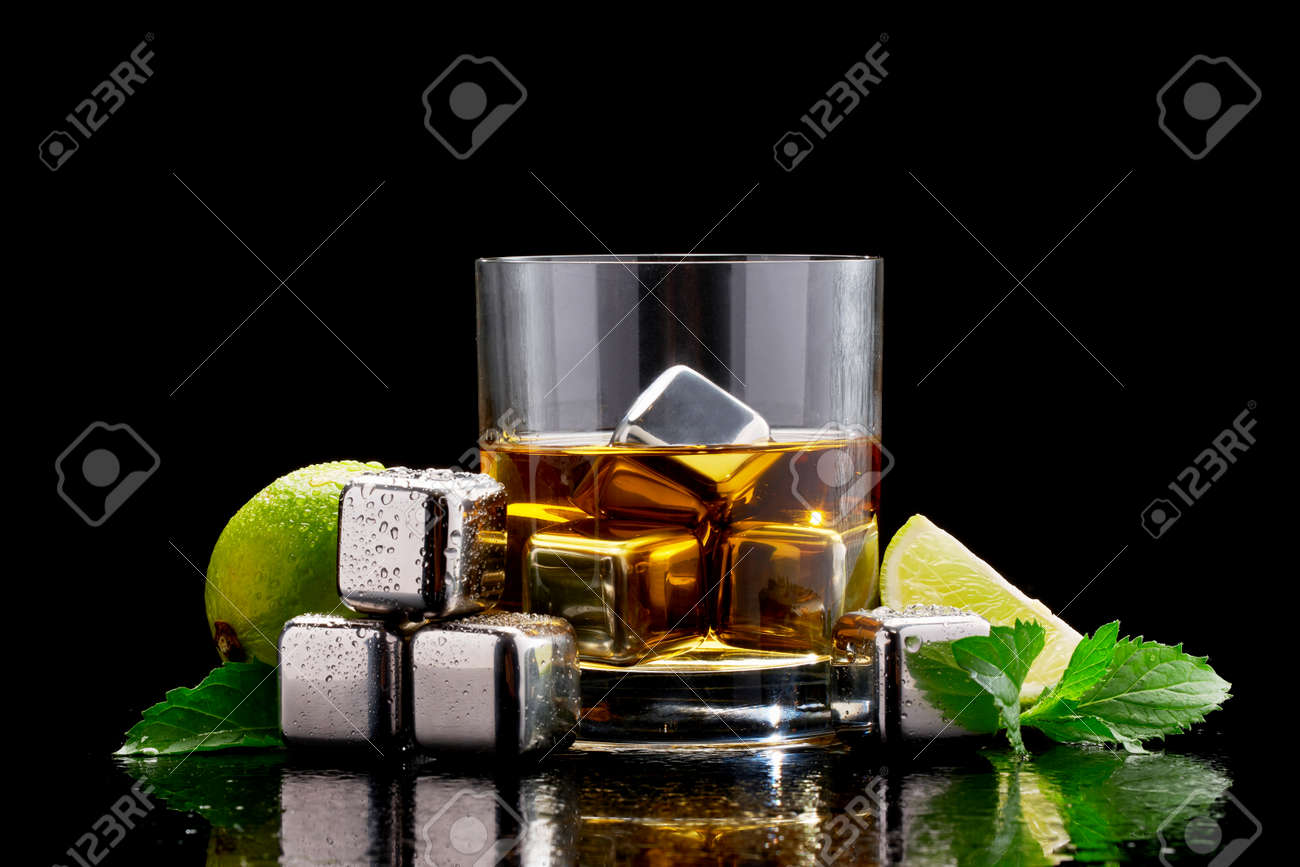 Whiskey with steel cooling cubes on dark glass background - 169835471 Whiskey with steel cooling cubes on dark glass background - 169835471
