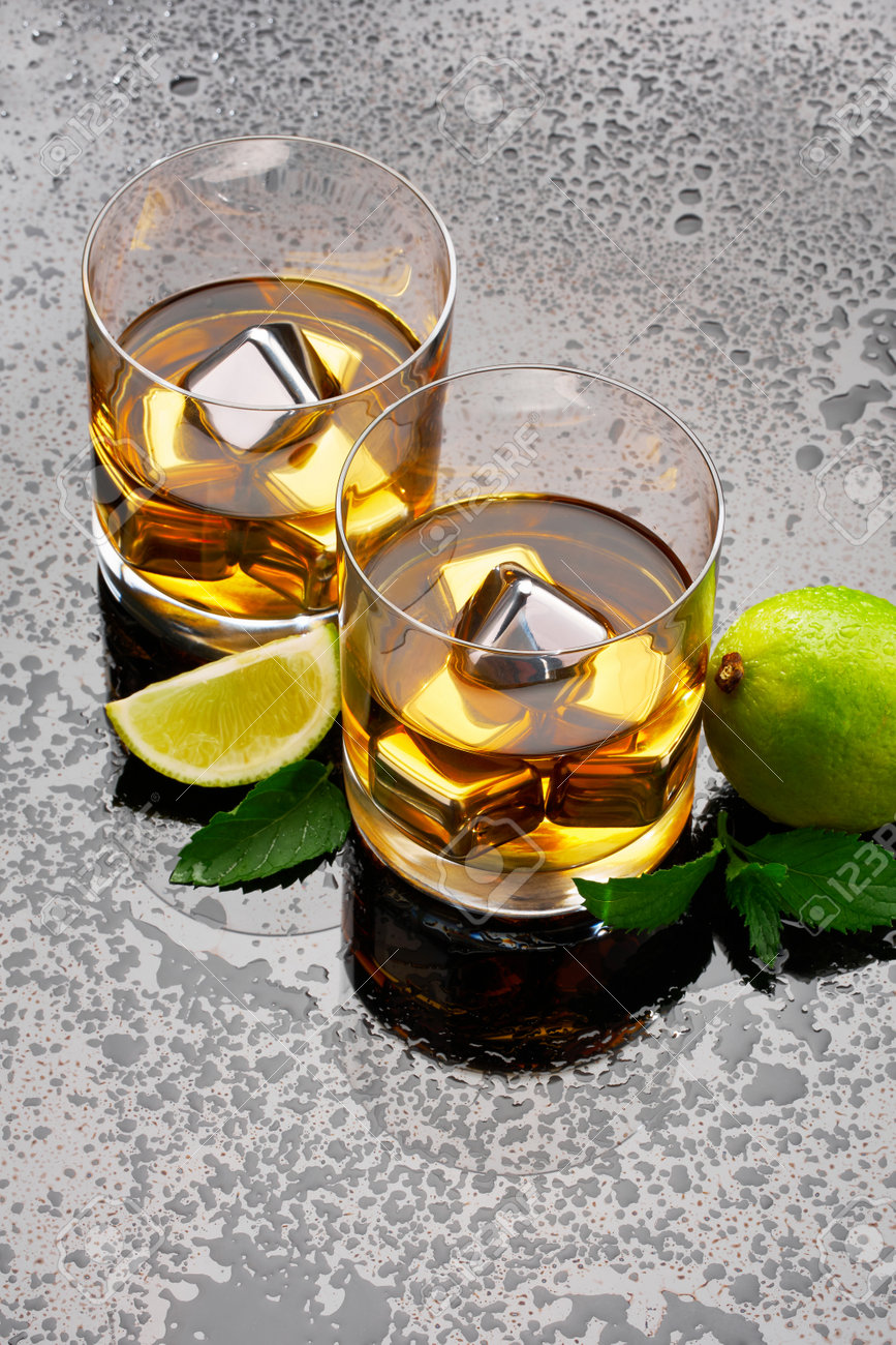 Whiskey with steel cooling cubes on dark glass background - 169835475 Whiskey with steel cooling cubes on dark glass background - 169835475