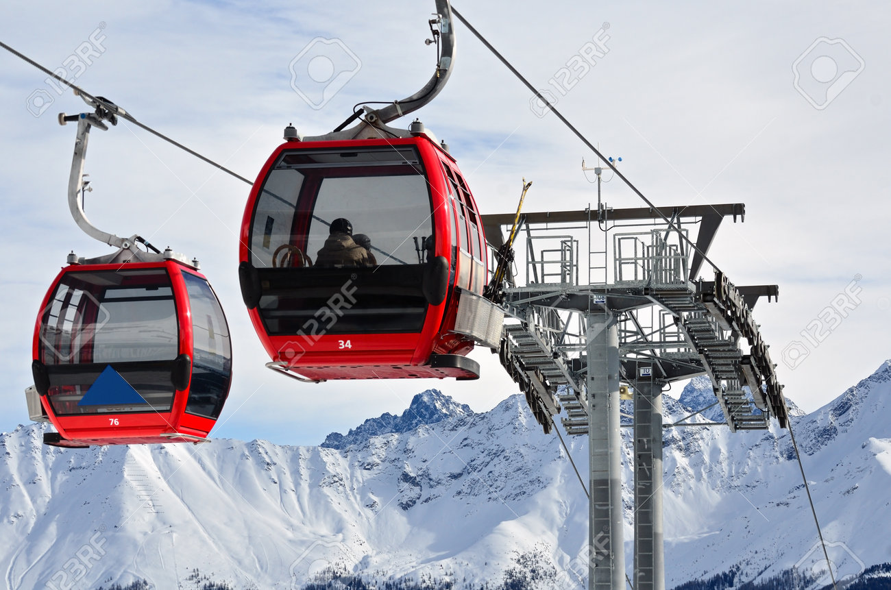 Red cable car in the skiing resort in Alps - 161006189 Red cable car in the skiing resort in Alps - 161006189