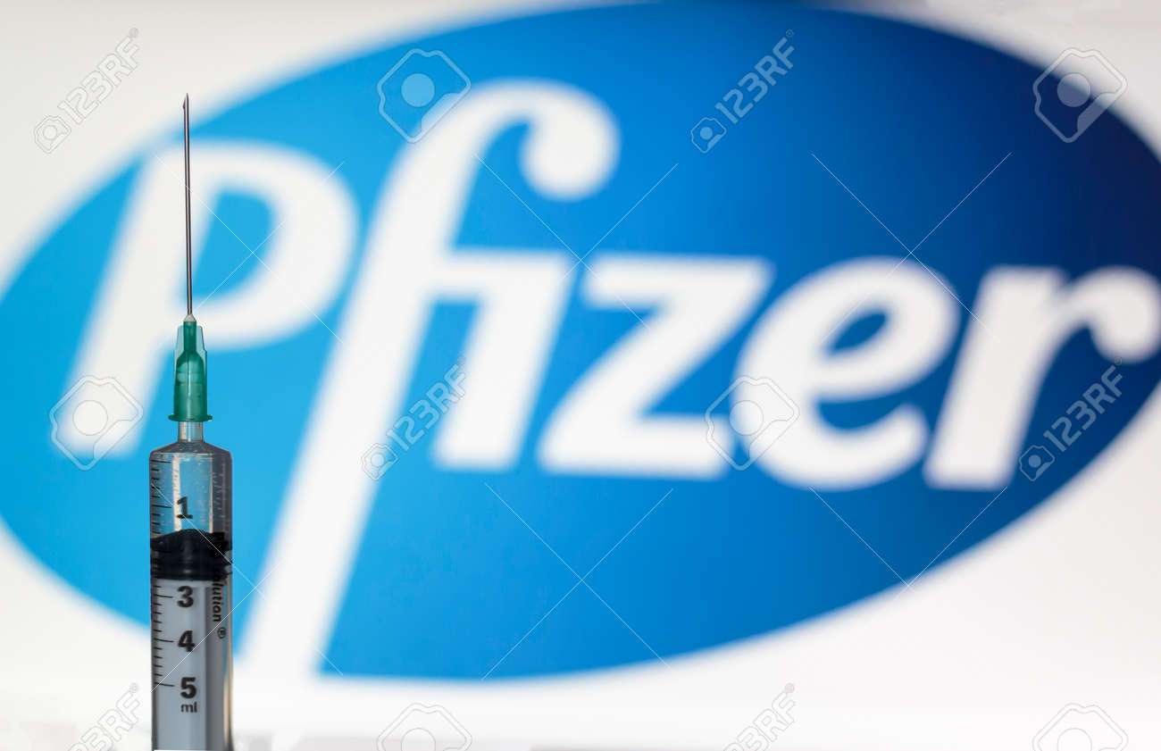 Lisbon, Portugal - November 22, 2020: Syringe and Pfizer logo on the background. Coronavirus, Covid-19 vaccine concept - 159416333 Lisbon, Portugal - November 22, 2020: Syringe and Pfizer logo on the background. Coronavirus, Covid-19 vaccine concept - 159416333