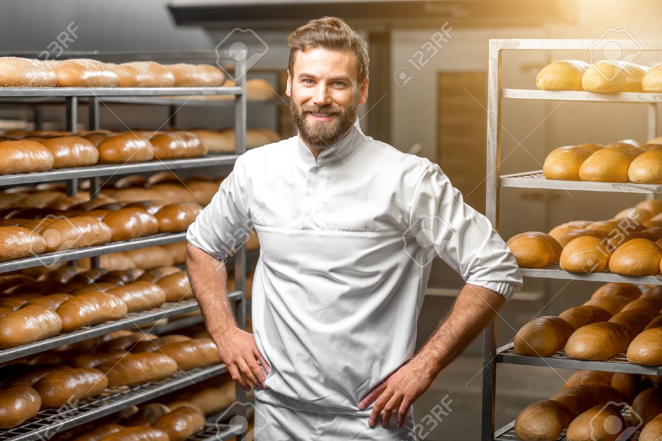 Portrait of handsome baker at the bakery with breads and oven on the background - 54120272 Portrait of handsome baker at the bakery with breads and oven on the background - 54120272