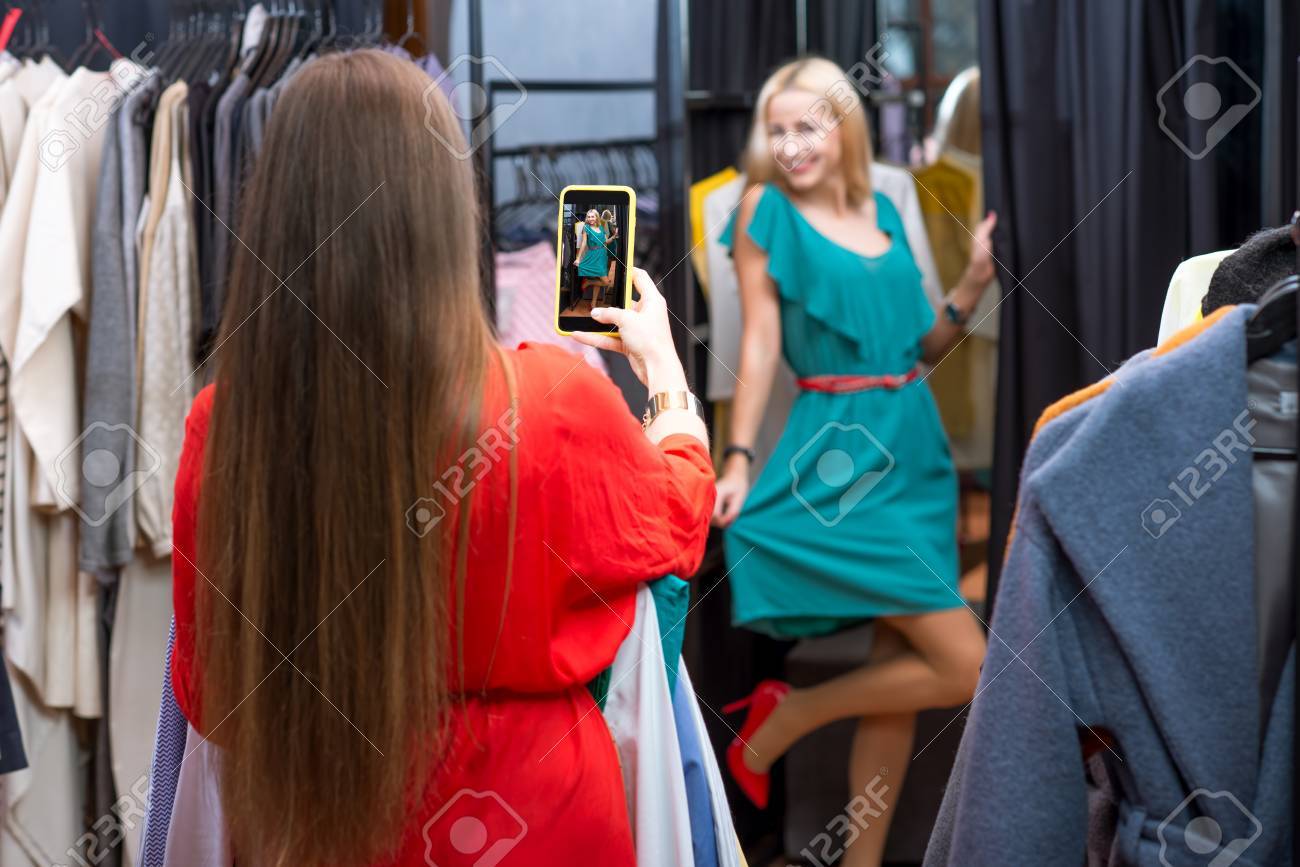 Happy Woman Trying A New Dress In The Wardrobe At The Clothing