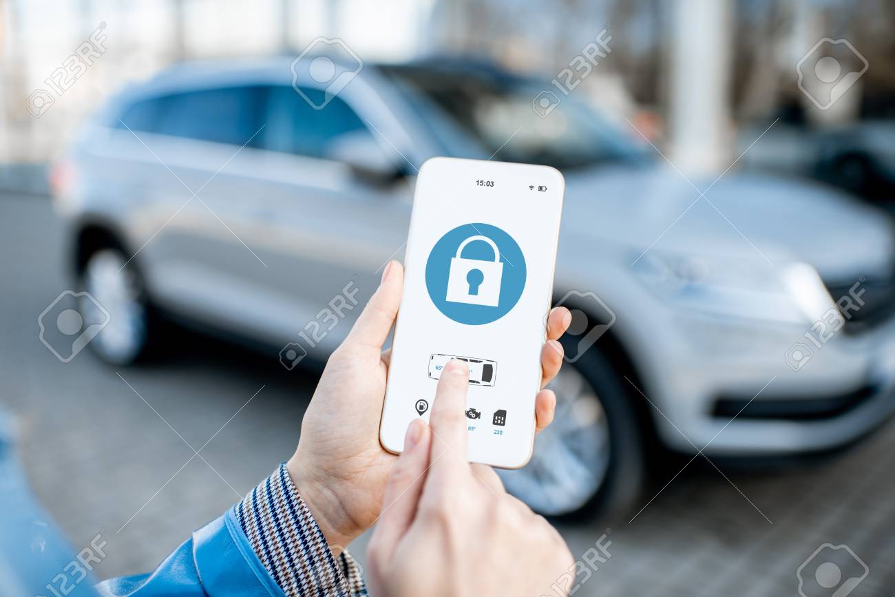 Locking car using mobile application on a smart phone. Concept of remote control and car protection through the internet - 119987399 Locking car using mobile application on a smart phone. Concept of remote control and car protection through the internet - 119987399