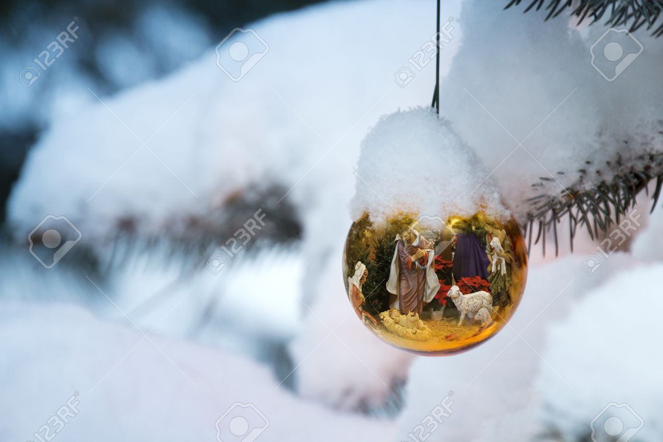 this christmas tree ornament brightly reflects a nativity scene