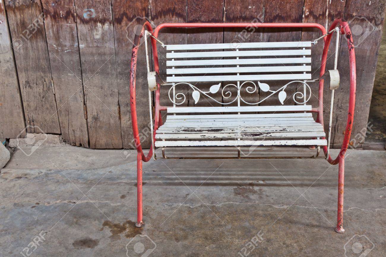 The old swing in front of the old wooden partition of a shophouse - 16801969 The old swing in front of the old wooden partition of a shophouse - 16801969