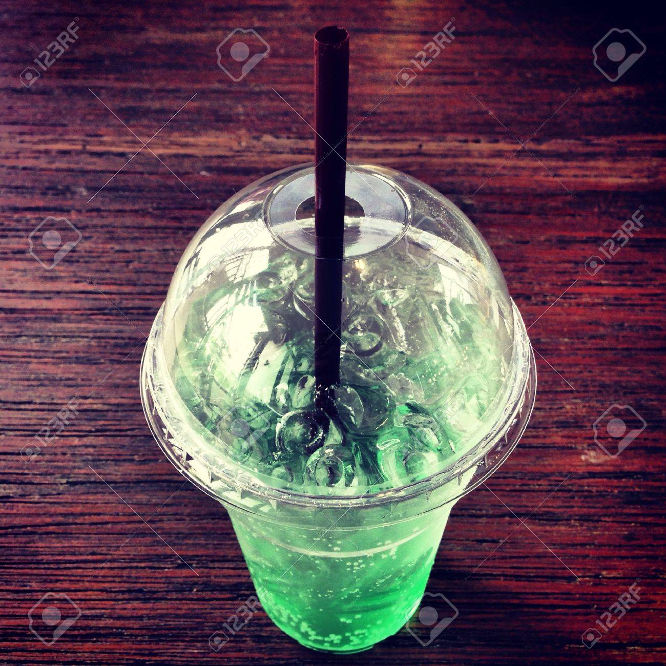 A glass of cold apple soda on the wooden table - 21480939 A glass of cold apple soda on the wooden table - 21480939