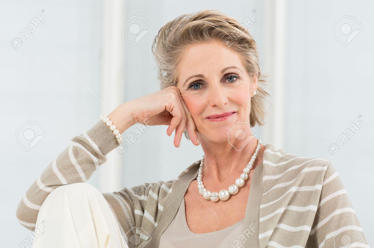 Portrait Of Happy Mature Woman Wearing Necklace Stock Photo