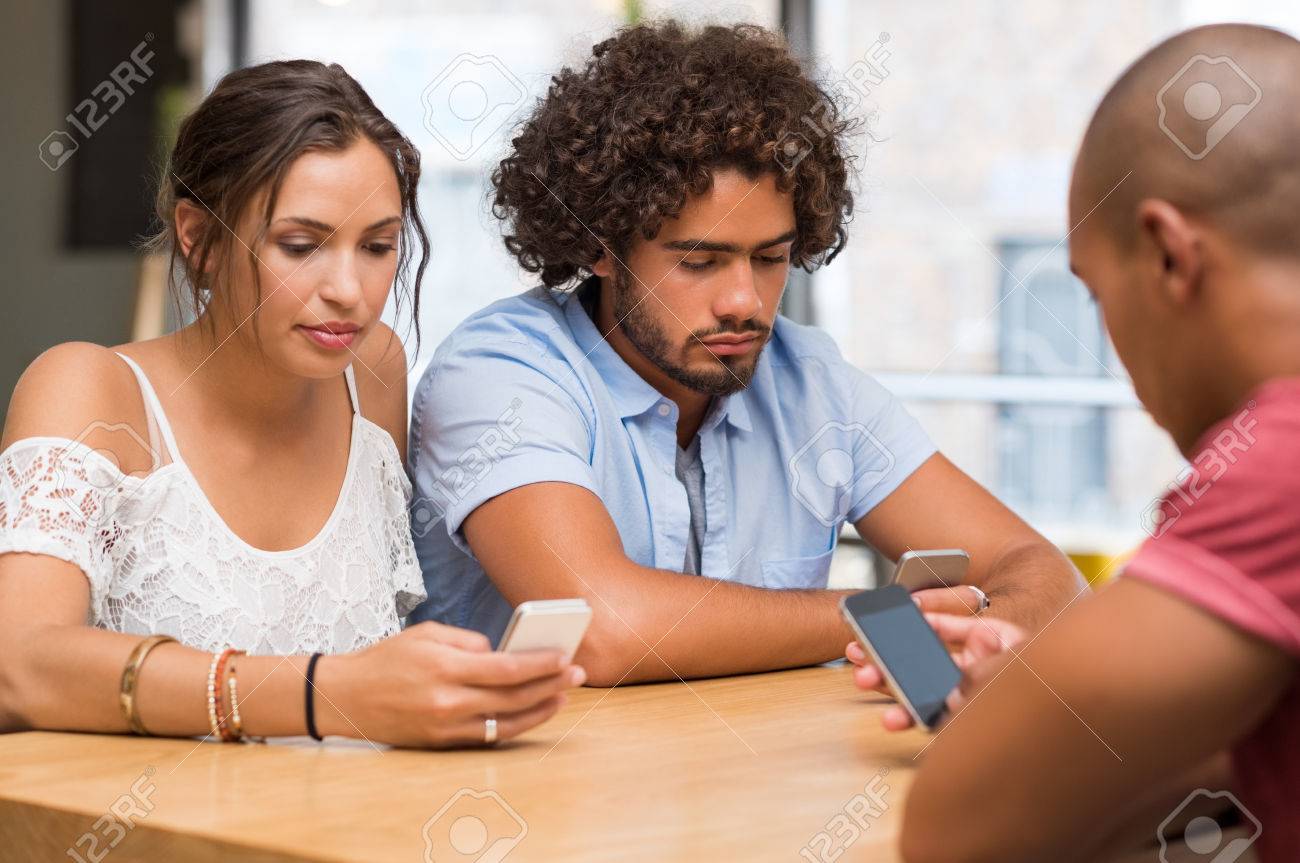 https://previews.123rf.com/images/rido/rido1607/rido160700025/59968113-group-of-friends-sitting-in-cafe-separately-looking-at-their-phone-losing-communication-young-men.jpg