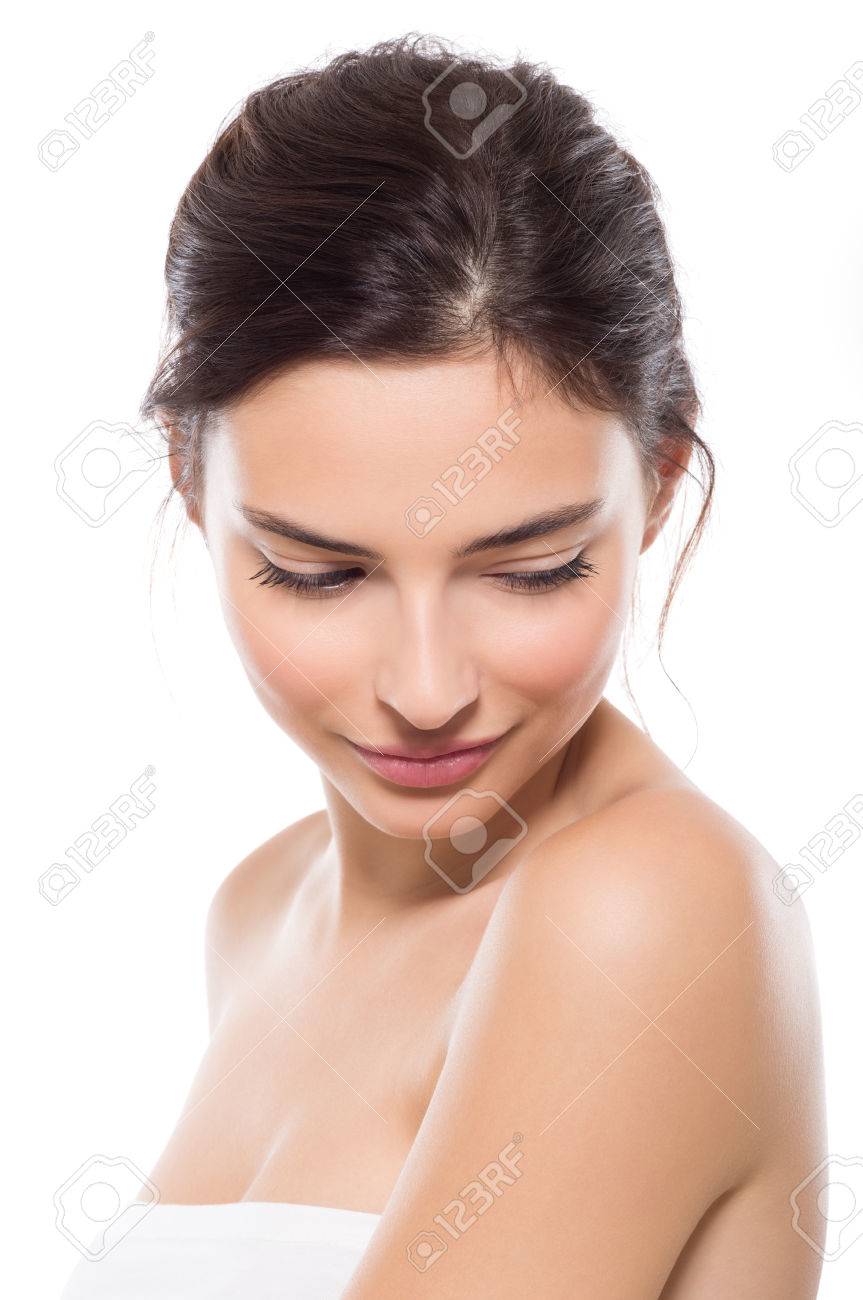 Young beautiful woman with perfect skin looking down. Close up face of beauty young woman. Young beautiful woman feeling shy isolated on white background. Wellness and skin care concept. - 65157777 Young beautiful woman with perfect skin looking down. Close up face of beauty young woman. Young beautiful woman feeling shy isolated on white background. Wellness and skin care concept. - 65157777