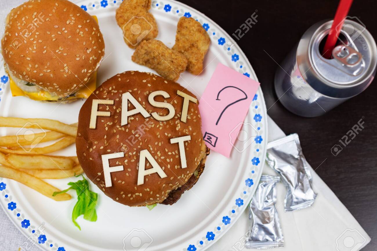 Juicy fast food burgers letters on a juicy burger. Unhealthy eating. Junk food concept. - 138721019 Juicy fast food burgers letters on a juicy burger. Unhealthy eating. Junk food concept. - 138721019