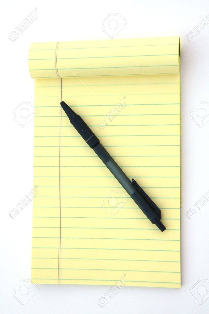 yellow legal pad of paper set against a white background stock photo