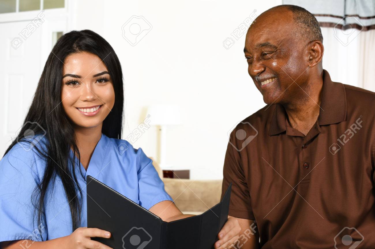 Nurse who is working her shift taking care of a patient - 65416490 Nurse who is working her shift taking care of a patient - 65416490